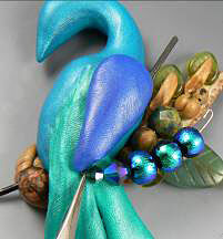 Beads being added to the clay peacock
